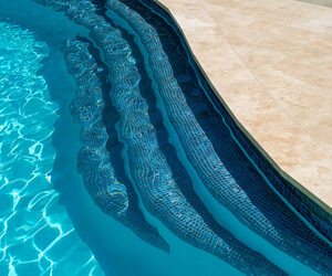 Travertine pavers and pencil-edge pool coping